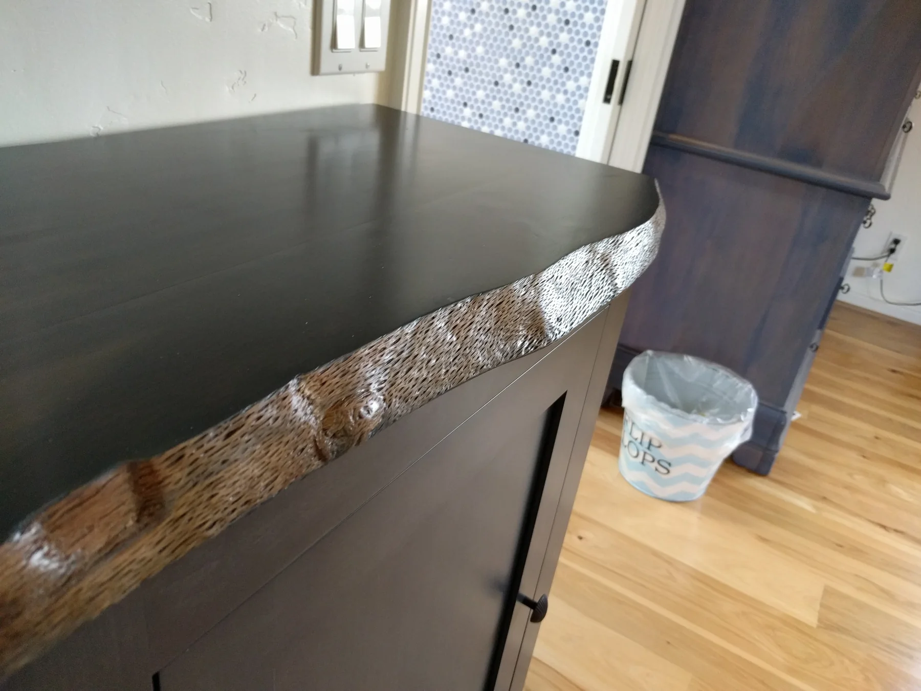 Natural-edge detail on the dark bathroom counter