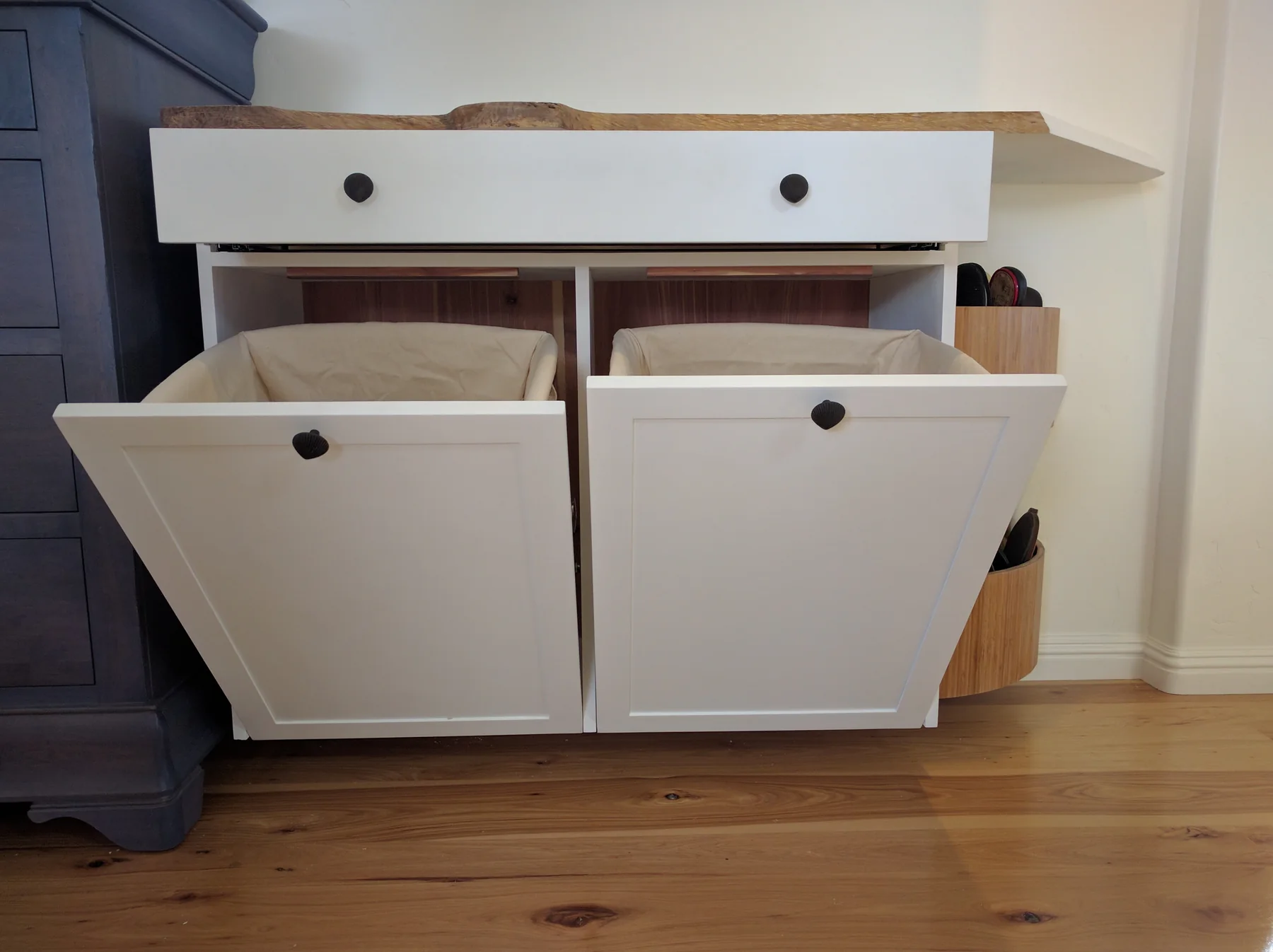 Two tilt-out shoe compartments open on a painted cabinet