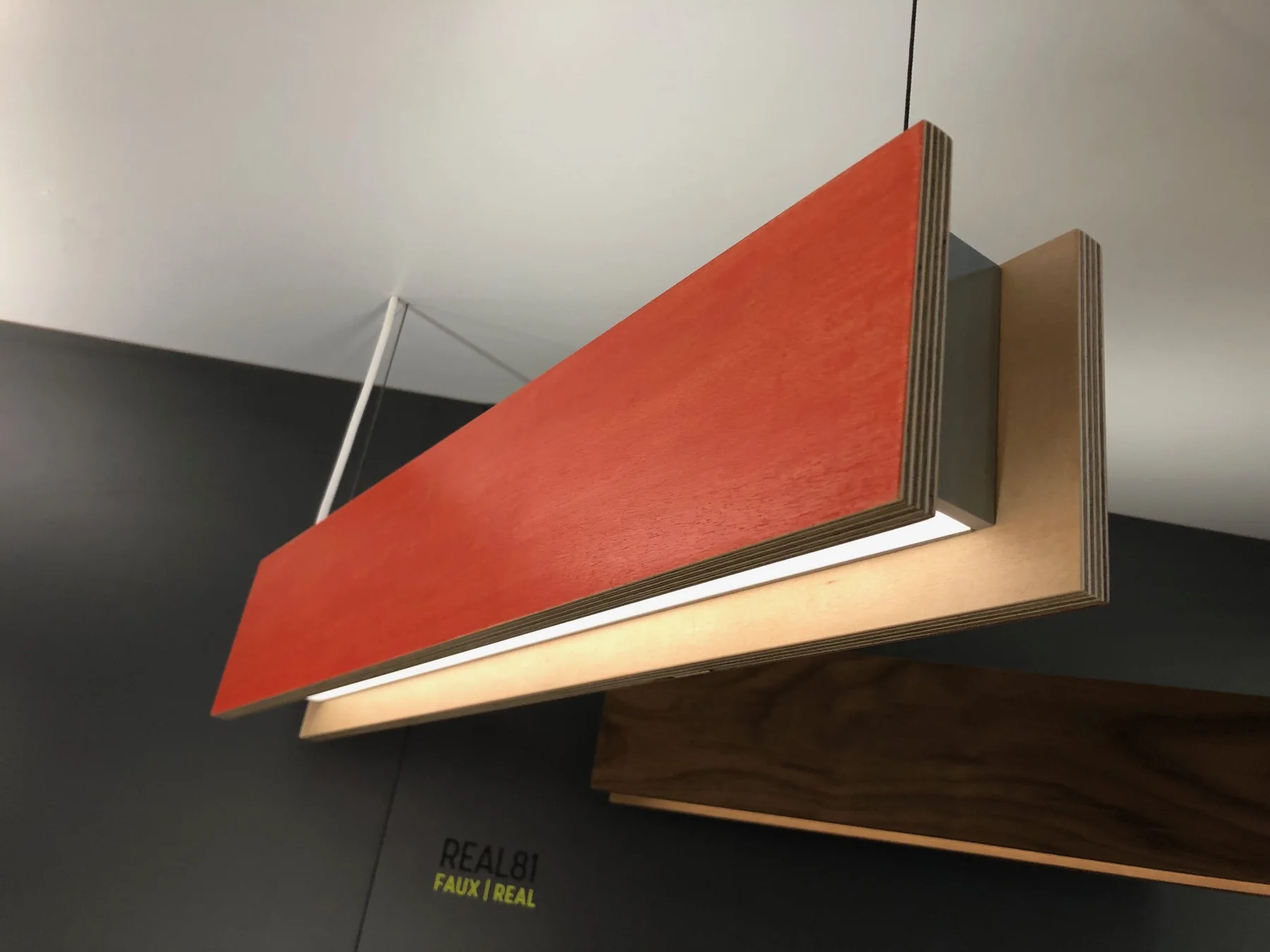 Close view of a wood pendant light with a layered edge