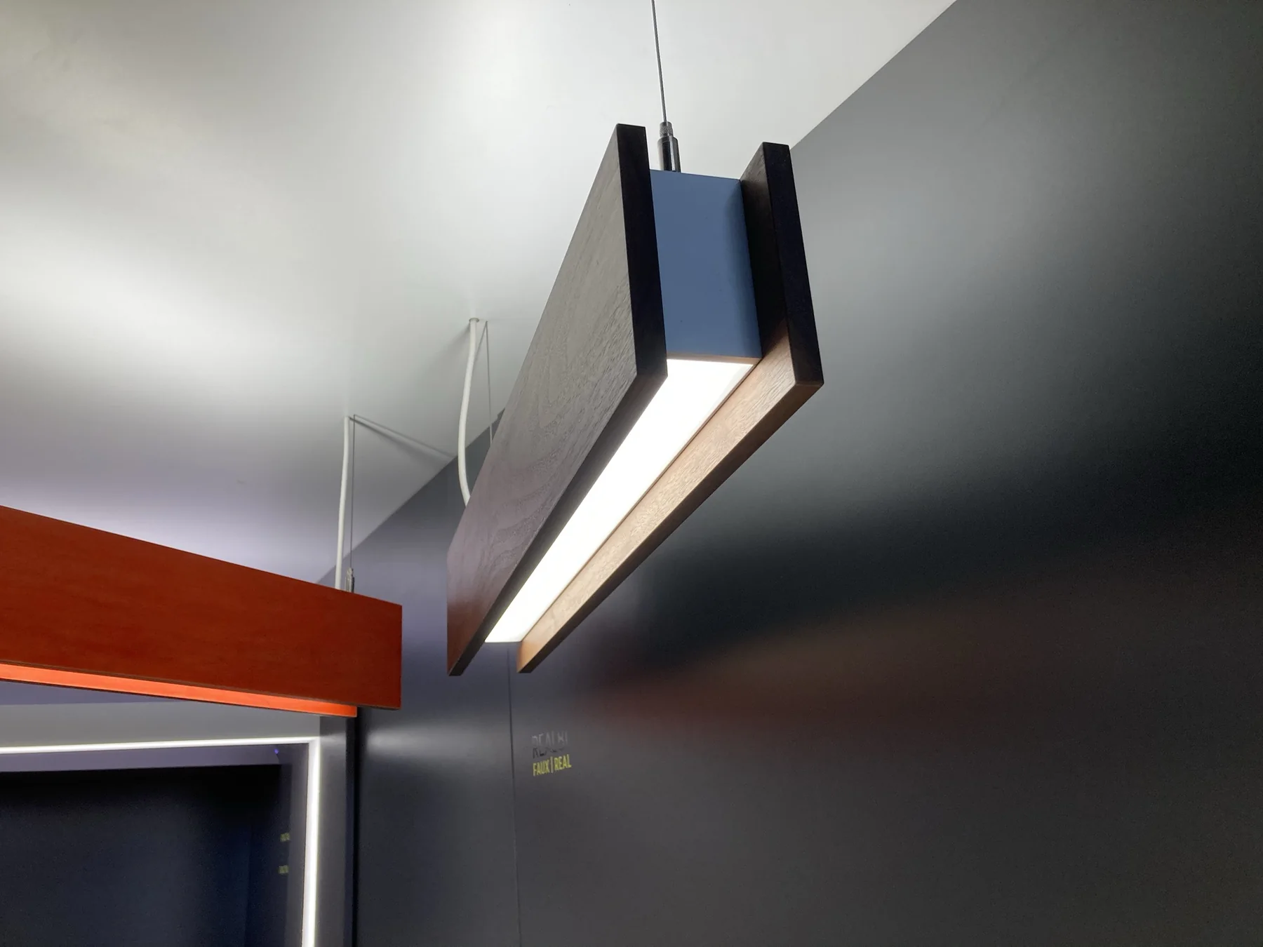 Close view beneath a walnut wood pendant light